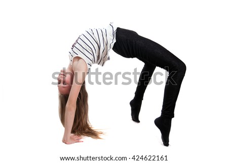A young girl is doing bridge pose in studio