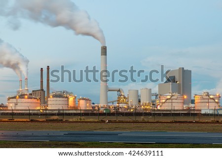 Oil refinery with smoking at twilight