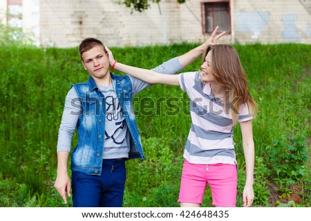 holidays, vacation, love and friendship concept - smiling teen couple young cheerful hipster Best Friends boy and girl having fun, played outdoors, mimic fight, positive emotions, facial expressions
