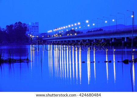 Long exposure image of "Songkhla Lake" on night view,the lights on Long concrete bridge.Soft focus, noise and grain due long exposure.