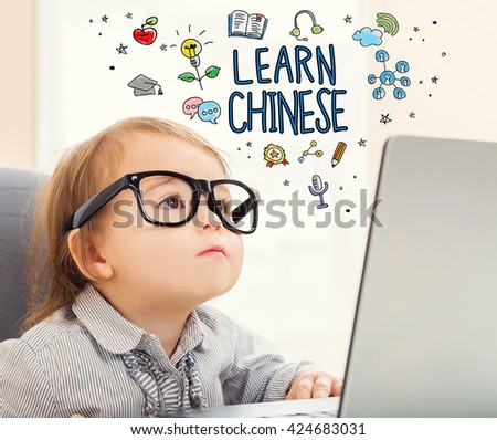 Learn Chinese concept with toddler girl using her laptop