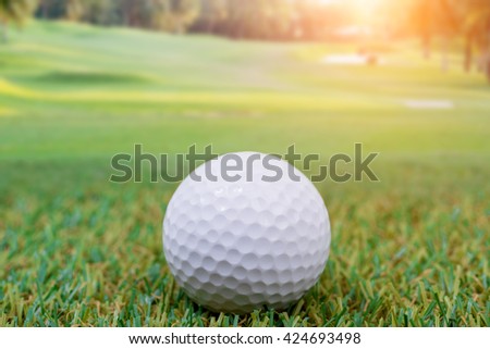 Golf ball in field on the green grass