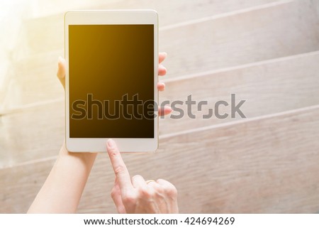 hand using tablet on top view with sunlight . Clipping path included.