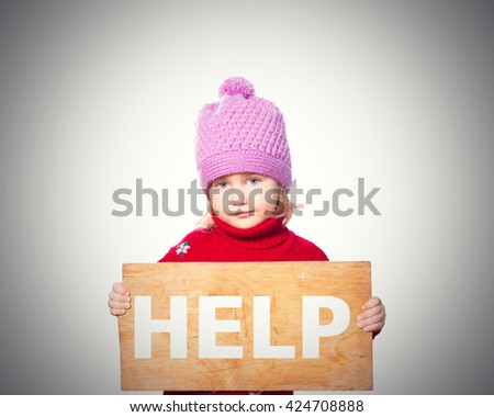 Little girl holding Board with inscription Help. Isolated on gray background