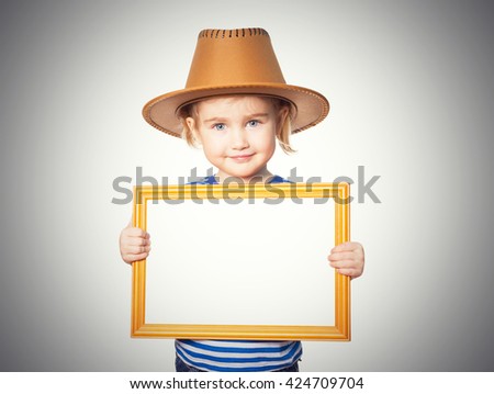 Little Funny girl in striped shirt and hat with blackboard. Isolated on gray background