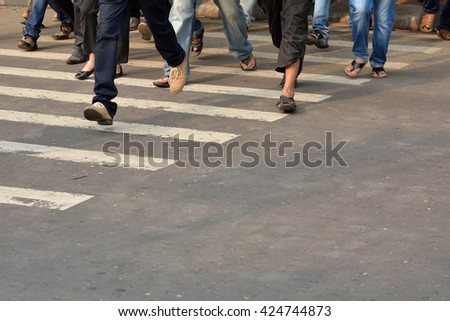 Pedestrian are crossing in zebra crossing.