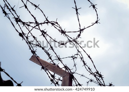 Tangle of barbed wire against the sky, Silhouette photo effect.