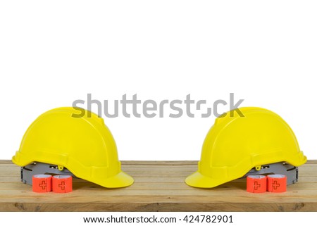 Reflective Bracelets or Safety Reflective Wristbands and Yellow Safety Helmet isolated on wood background