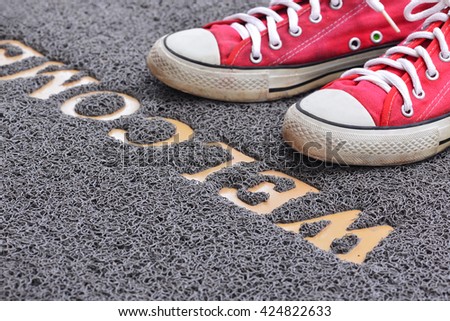 Welcome carpet with foot-ware on it
 Royalty-Free Stock Photo #424822633