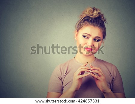 Closeup portrait of sneaky, sly, scheming young woman plotting something isolated on gray background. Negative human emotions, facial expressions, feelings, attitude Royalty-Free Stock Photo #424857331