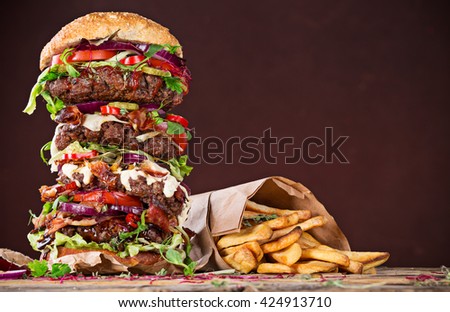 Close-up of home made tasty big burger on wooden table.
