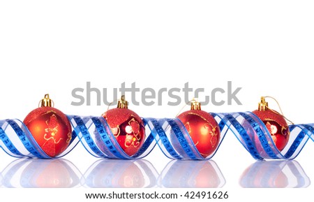 four red xmas balls between blue shiny ribbon