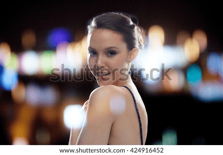 beauty, jewelry, people and luxury concept - beautiful young asian woman with earring over night lights background