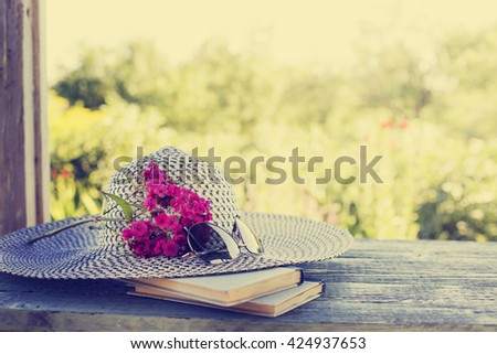 summer hat ,Vintage books with bouquet of field flowers/ nostalgic summer background