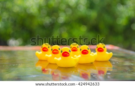 Duck dolls, toys for children, on a table made of wood and background bokeh tree. (Select focus)