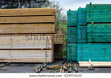 a lot of sawmill raw wooden boards, in a pile, drying process, cyan tinting