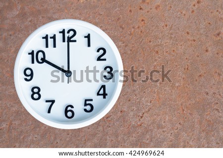Clock show 10 am or pm on steel rusty background with copy space. clipping path in picture.