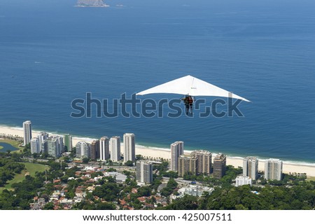 A hang glider flying from Pedra Bonita toward the beach at São Conrado, Rio de Janeiro, Brazil