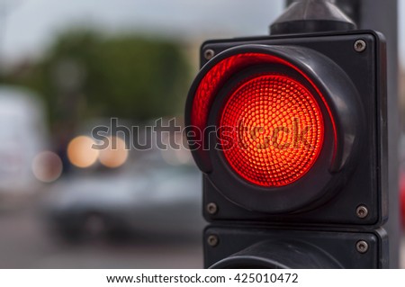 Red traffic light in the city street Royalty-Free Stock Photo #425010472
