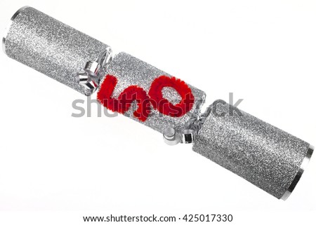 A shot of a 50th Birthday or Anniversary Cracker also known as a Bon Bon.  A cracker consists of a cardboard tube wrapped in a brightly decorated twist of paper with a gift in the central chamber.