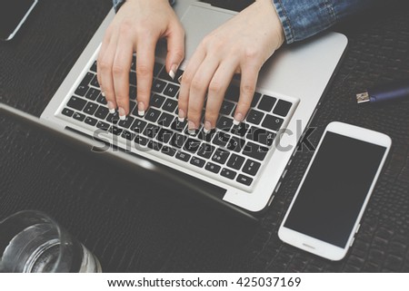 Cropped image of woman typing on laptop