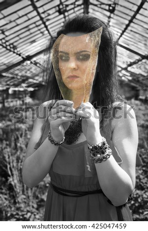 photo of the girl looking at black-and-white world through colored glass