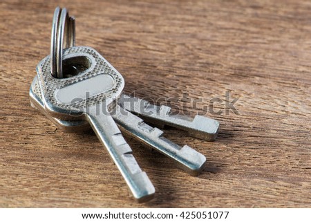 Silver key on vintage wooden background