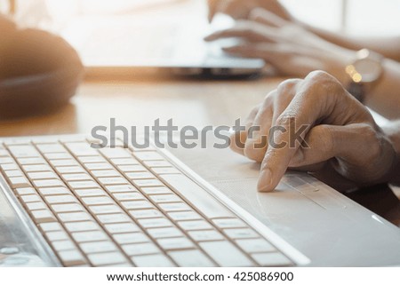 Close up of hand of business man working document and laptop in meeting room, boring light.
