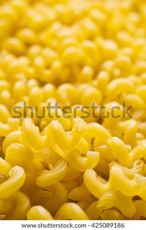 Background of dry pasta cavatappi. Selective focus.