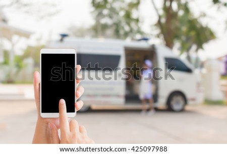 woman use mobile phone and blurred image of the ambulance with a nurse