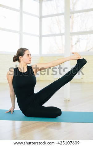Beautiful yoga woman practice in a training hall background. Yoga concept.