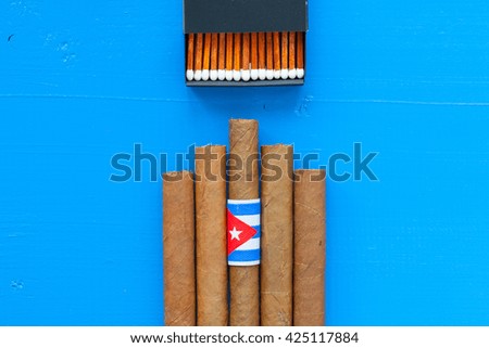 Detail of luxury Cuban cigars on the blue desk