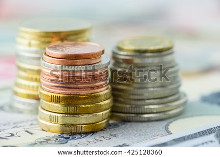 Close up view : stacks of coins in many colors i.e. silver, gold and copper. Various types and sizes of coins / currency, can be used as montage background, layer processing, editing, photo merge, etc