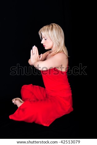 Business woman doing joga at lunch break ,  isolated on black
