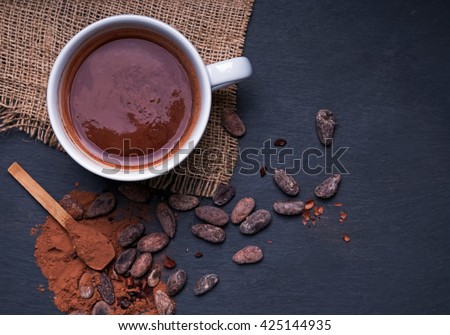 Hot chocolate in a cup, dark styled photo, top view
