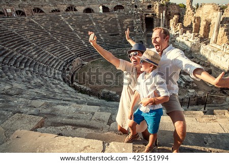 Funny family take a self photo in amphitheater building