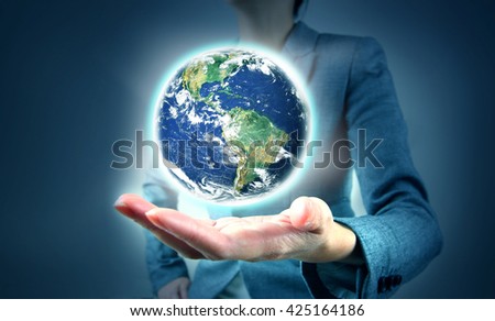 holding a globe in hand. Elements of this image furnished by NASA