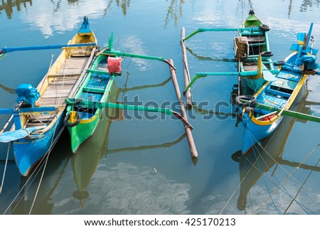 Detail of traditional wooden Indonesia colored boats anchored at Pengambengan harbor in Bali Island (Barat). Indonesia