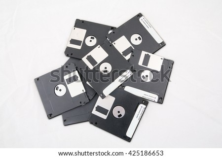 Top view of a pile of floppy disk in the studio, isolated on white background