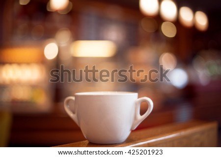 cup of coffee  on wooden table. picture wiyh soft focus