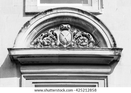 Georgian curved pediment with sculpture black and wheel photography high contrast