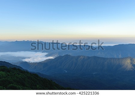 View of mist on the mountain at sunrise over mountain range, mountain gap, mountain layer at Doi Pha Hom Pok National Park, chiang Mai, Thailand