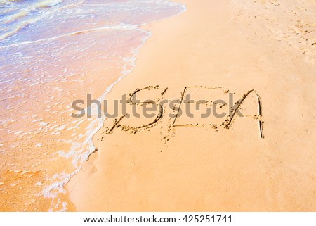 Written sea on sand at the coast, background