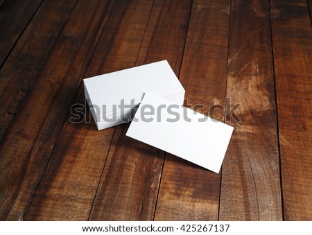Photo of blank business cards. Blank business cards on vintage wooden table background. Template for ID. Mock-up for branding identity.