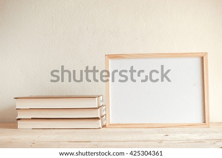 white board and book on wood table - vintage style tone