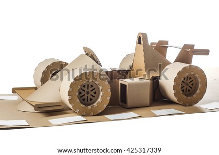 Photo of cardboard racing car on white background
