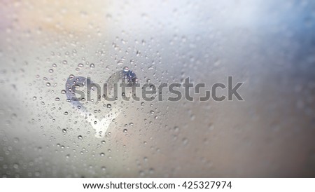 "Love rain and bokeh light", view through the windshield of strong rainy day. Abstract of defocused bokeh lights background.