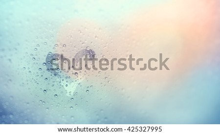 "Love rain and bokeh light", view through the windshield of strong rainy day. Abstract of defocused bokeh lights background. Royalty-Free Stock Photo #425327995