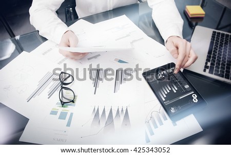 Brand Management Work Time process.Photo Trader working Market Report Documents Touching Screen Tablet.Using Graphic Icons,Stock Exchanges Reports. Business Project Startup. Horizontal, .