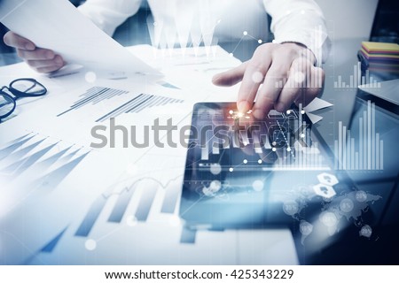 Risk Management Work process.Photo Trader working Market Report Documents Touching Screen Tablet.Using Graphic Icons,Stock Exchanges Reports. Business Project Startup. Horizontal, Flares Effect.